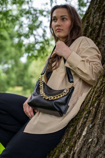 Black Leather Handbag with Metallic Accents & Straps